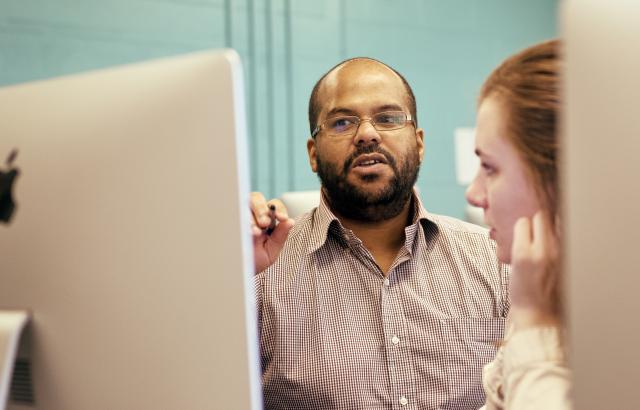 Graphic Design professor George Ramirez in class in the Dower center