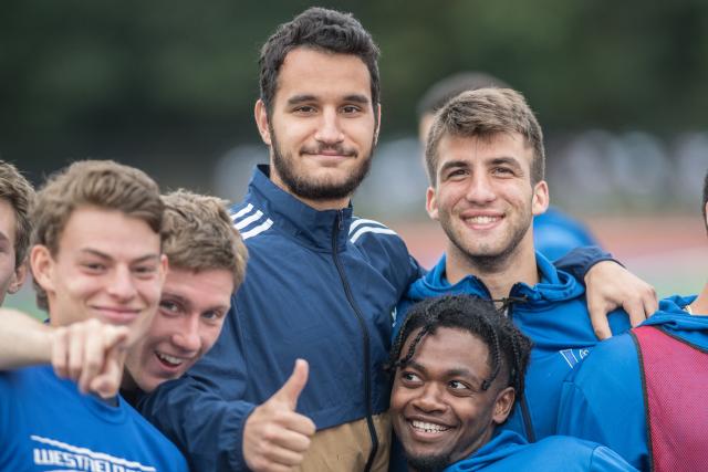 Members of the WSU men's soccer team gather and mug for the camera after a training session