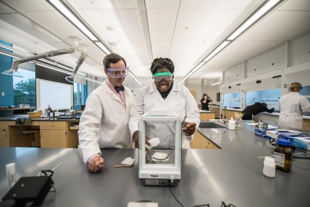 Dr. Chris Masi assists one of his students measure a sample in a Stevens Center lab