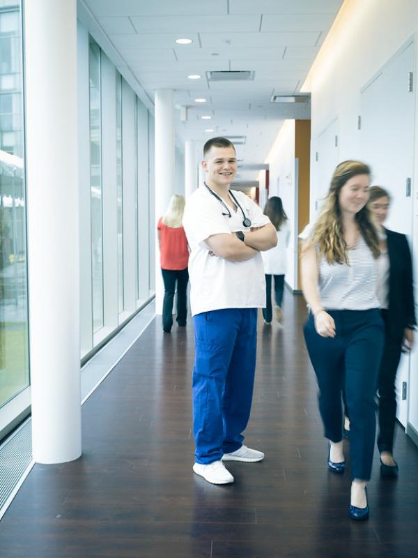 Male nursing student in the hallway outside the simulation labs in the Stevens Center