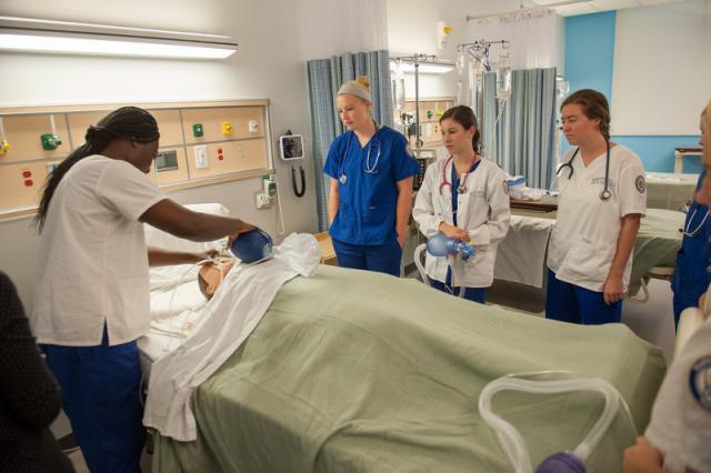 Nursing students demonstrate how to properly bag a patient in the simulation lab