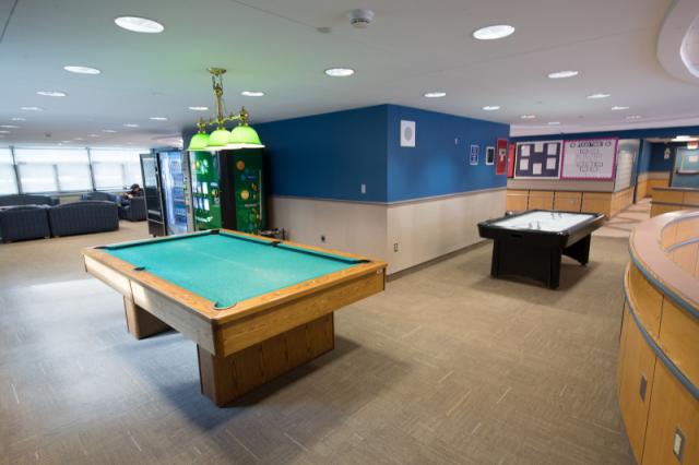 Interior view of the Lammers Hall lobby with pool table and air hockey table 