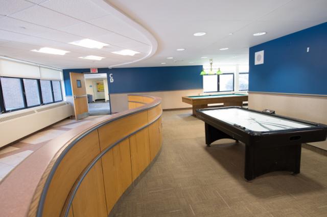 Interior view of the Lammers Hall lobby with pool table and air hockey table 