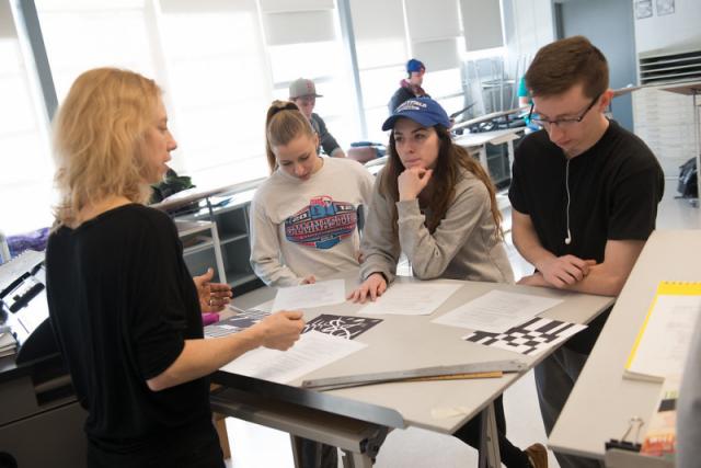 Art professor gives students a classroom assignment in shape and form