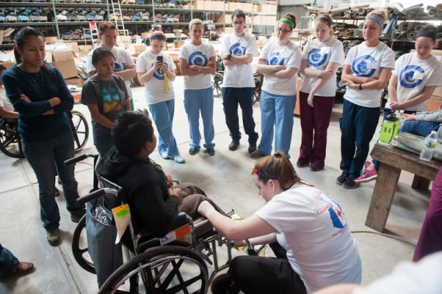 Nursing students in Guatemala help assemble wheelchairs for local residents in need