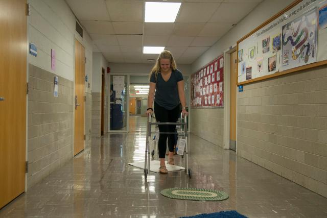 A Health Sciences student negotiates obstacles with a walker