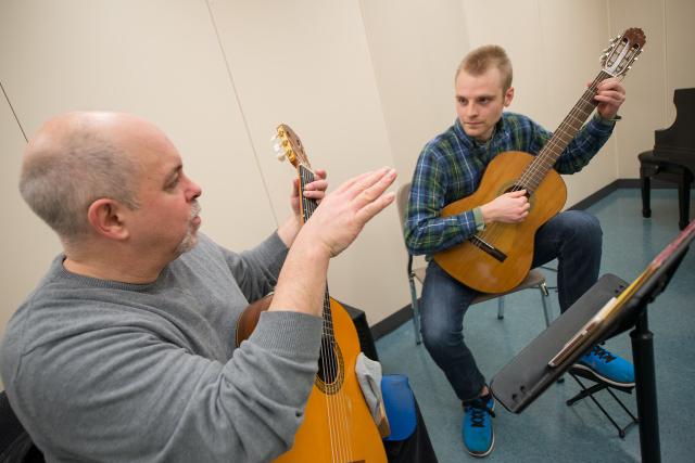 A Westfield State guitar instructor with guitar student