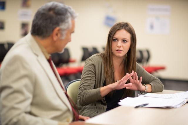 A Westfield State student in conversation with Professor Michael Filas of English