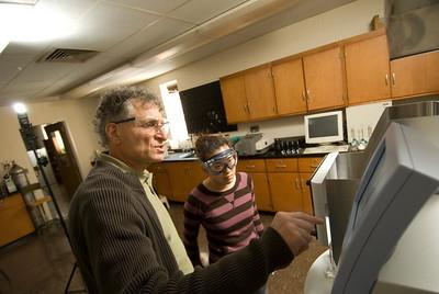Professor Patrick Romano works with a student
