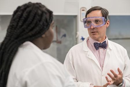 Professor Chris Masi and a student discuss lab procedures