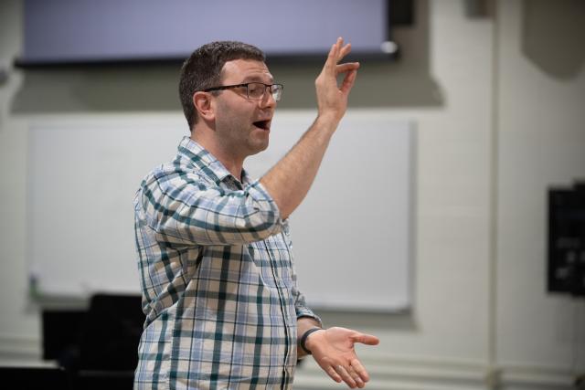 Scott Bailey, staff assistant of music department and collaborative pianist and director of the Westfield University Chorus conducts a rehearsal in the Dower Center