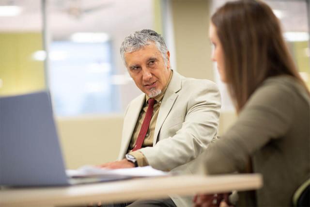 A Westfield University professor talks one-on-one with a student.