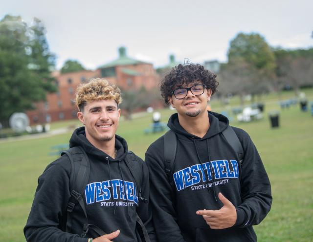 Two male students, in WSU sweatshirts, smile at the camera