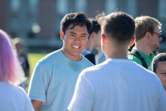 Student on campus talking with another student at club's fair