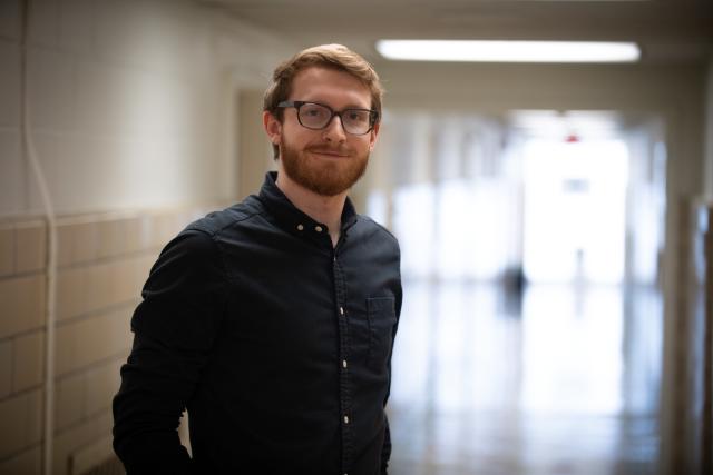 MSW Graduate Student Smiling in Academic Building Hallway