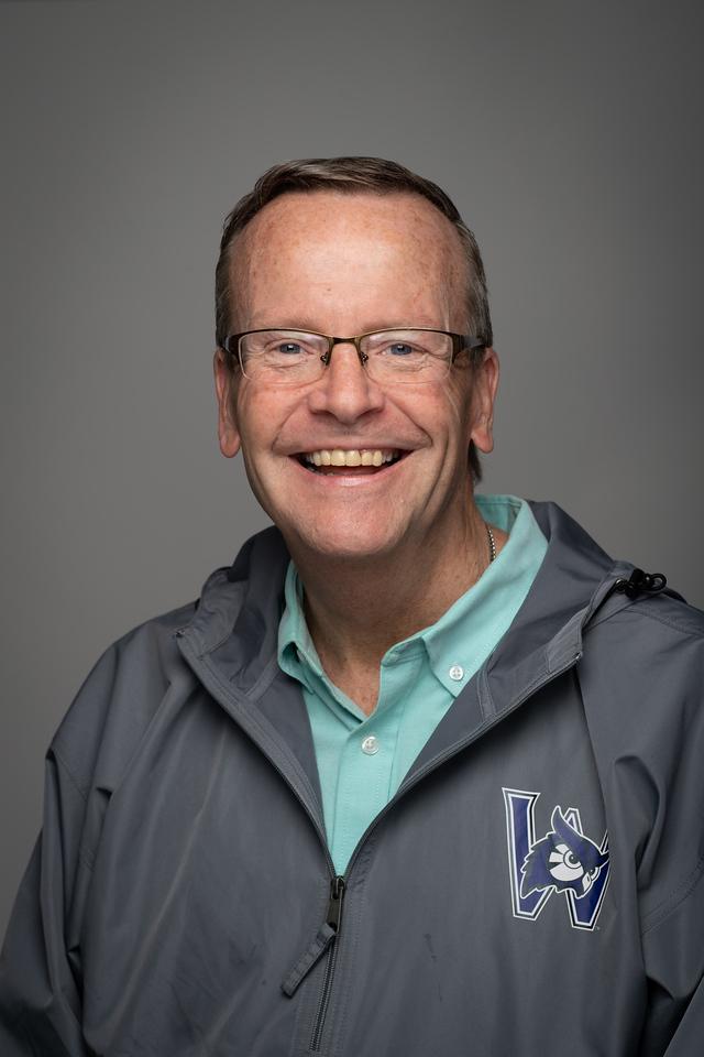 Timothy Rooke wearing WSU jacket light blue shirt and glasses.