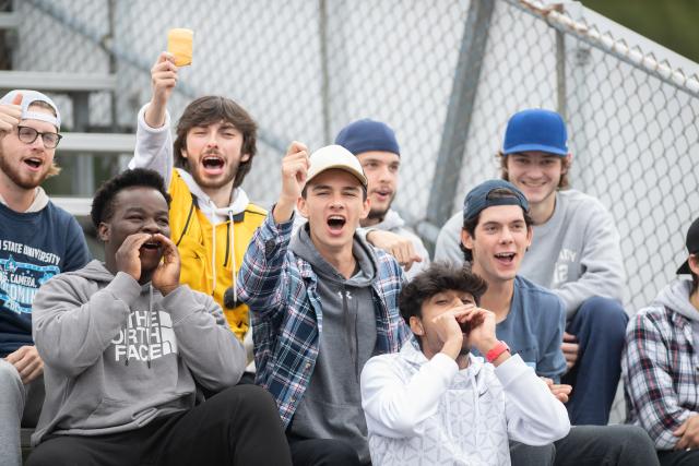Students cheer on the men's soccer team at alumni field