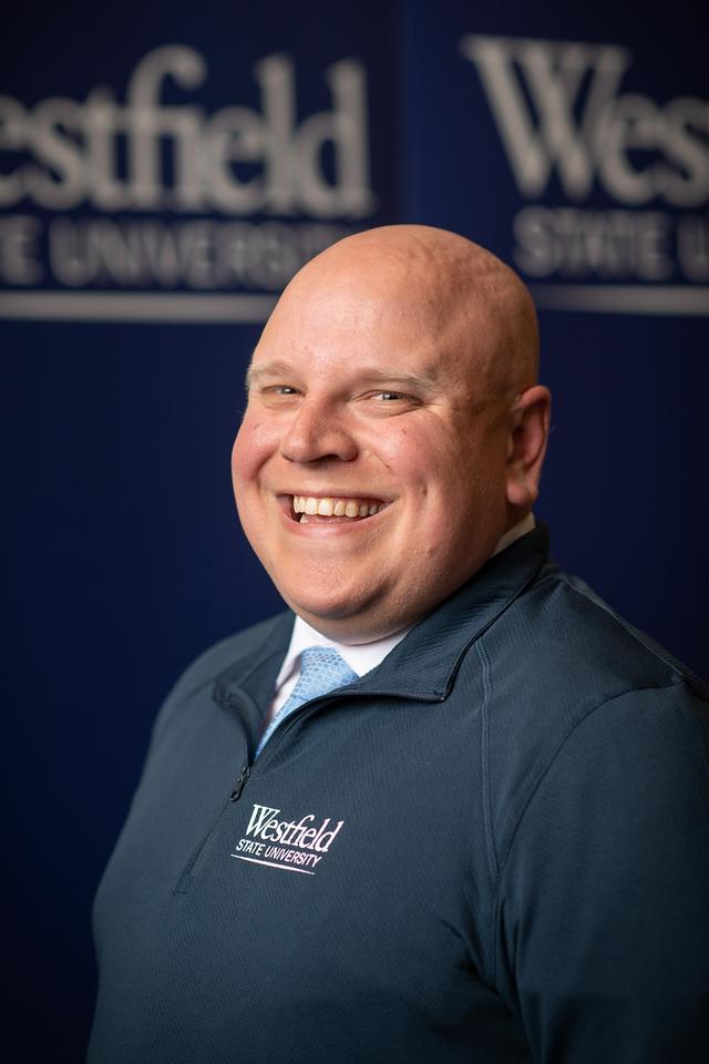 Mike Director of Admission smiling wearing navy long sleeve WSU shirt
