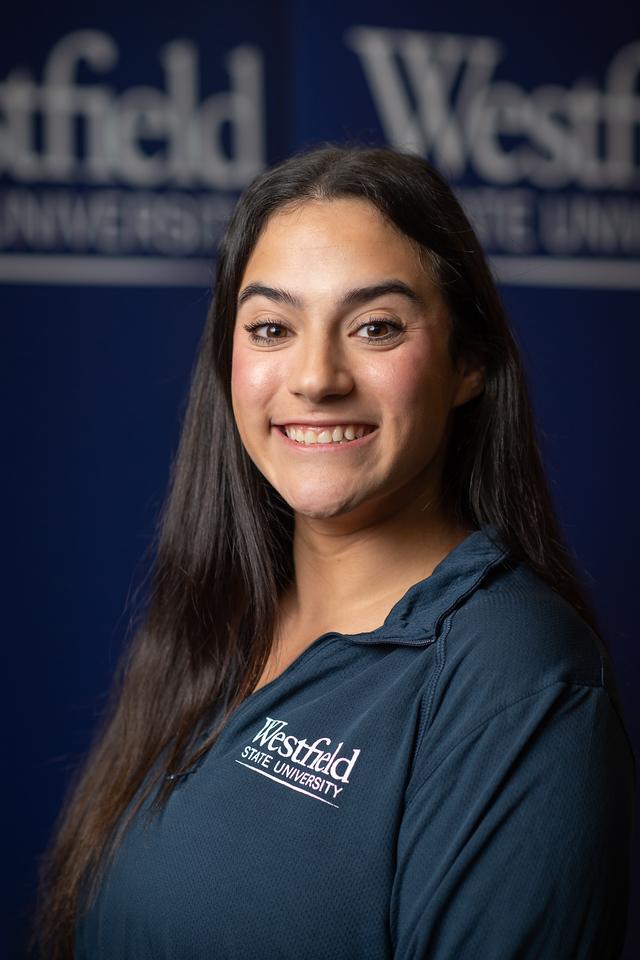 Philecia Admission Counselor smiling with dark long hair wearing navy blue polo shirt with WSU logo.