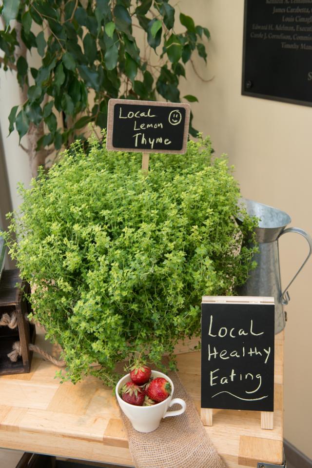 Local healthy eating sign with thyme plant and strawberries