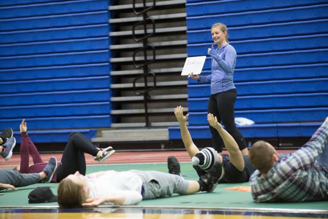 Movement science student instructing a class in gym.