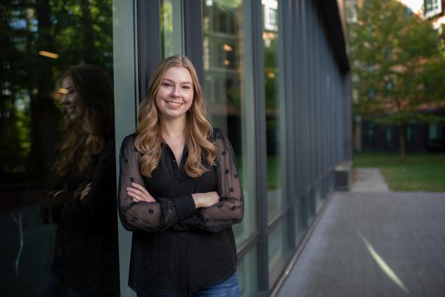 Counseling graduate student smiling in front of the Nettie Stevens Science Center.