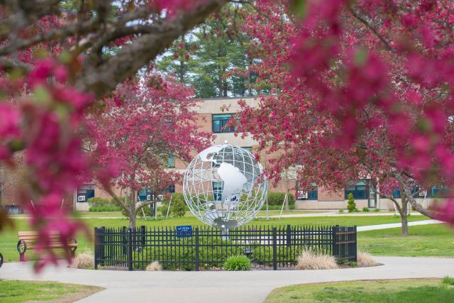 The WSU Globe surrounded by spring blossoms on the campus green