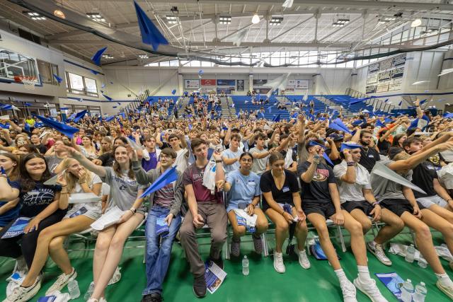 Students launching paper planes during a group meeting at Welcome Week.