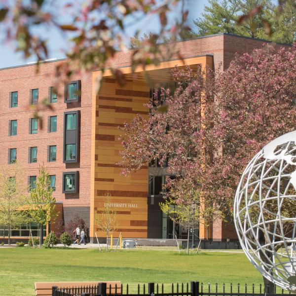 Globe on the campus green with University Hall in the background