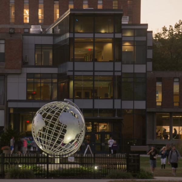 Globe on the campus green during early evening, with the Campus Center in the background