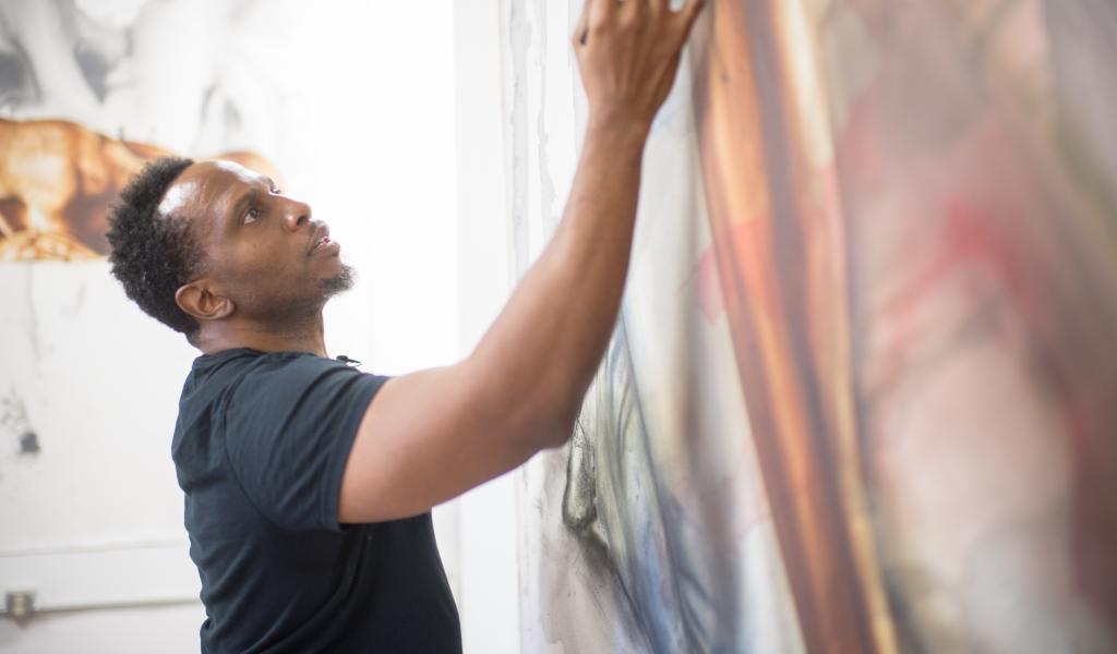 Art professor, Imo Imeh, working on one of his large canvases in his studio