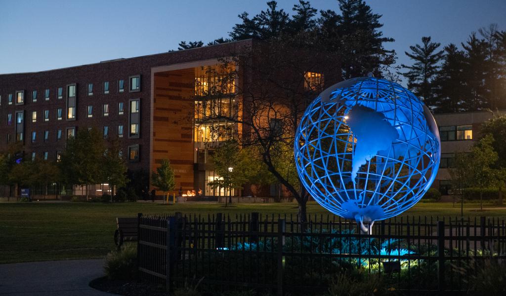 Globe Illuminated Blue with University Hall in Background