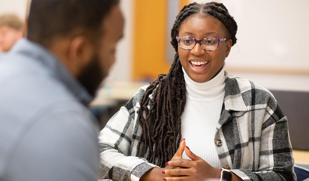MPA student smiles at classmate.