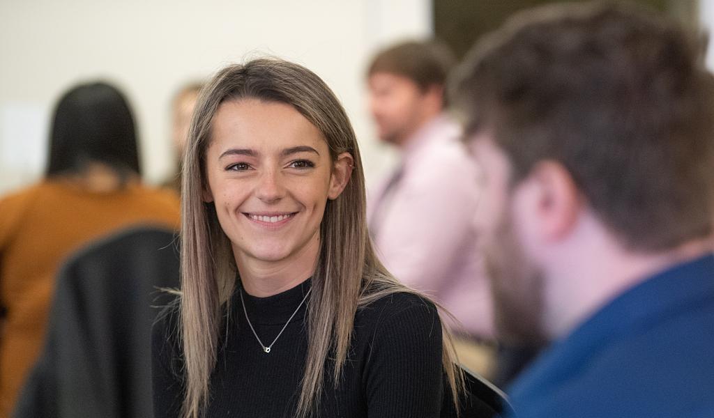 Female student smiling at classmate