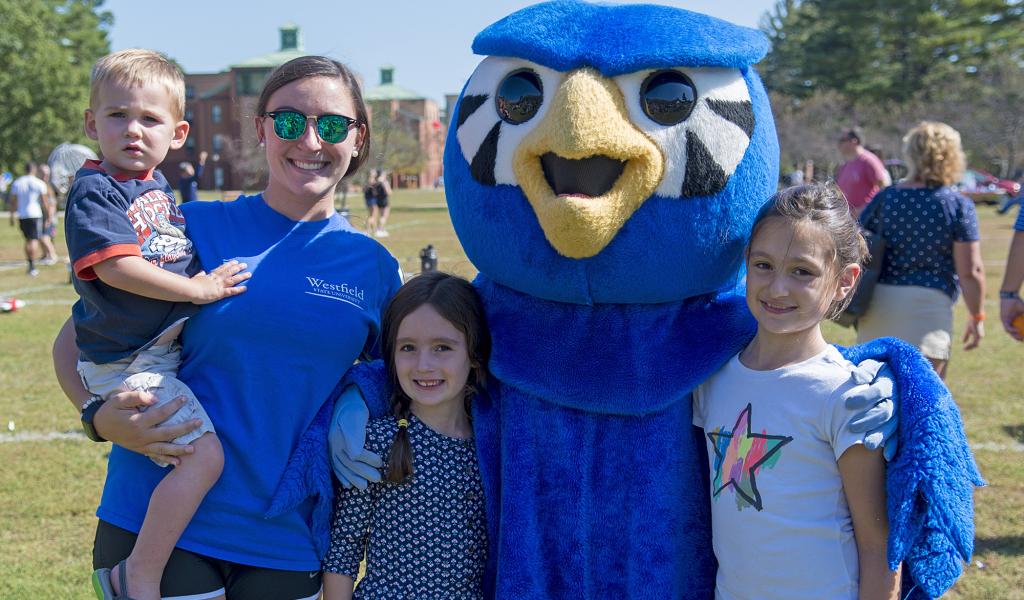 Nestor with a WSU student, and three young children on the campus green