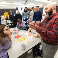 Alex Moore teaching students in a classroom