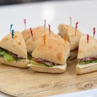 Sandwich platter featuring turkey and roast beef sandwiches on ciabatta rolls