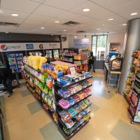 Marketplace store with fruit and shelves with candy and snacks.