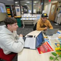 Two students in the CARE Center with laptops.