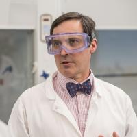 Professor Christopher Masi wearing lab coat and eye protection.